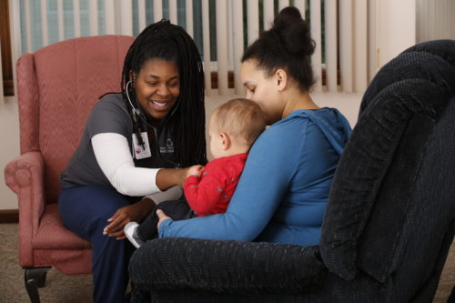 Nurse meets with client and child