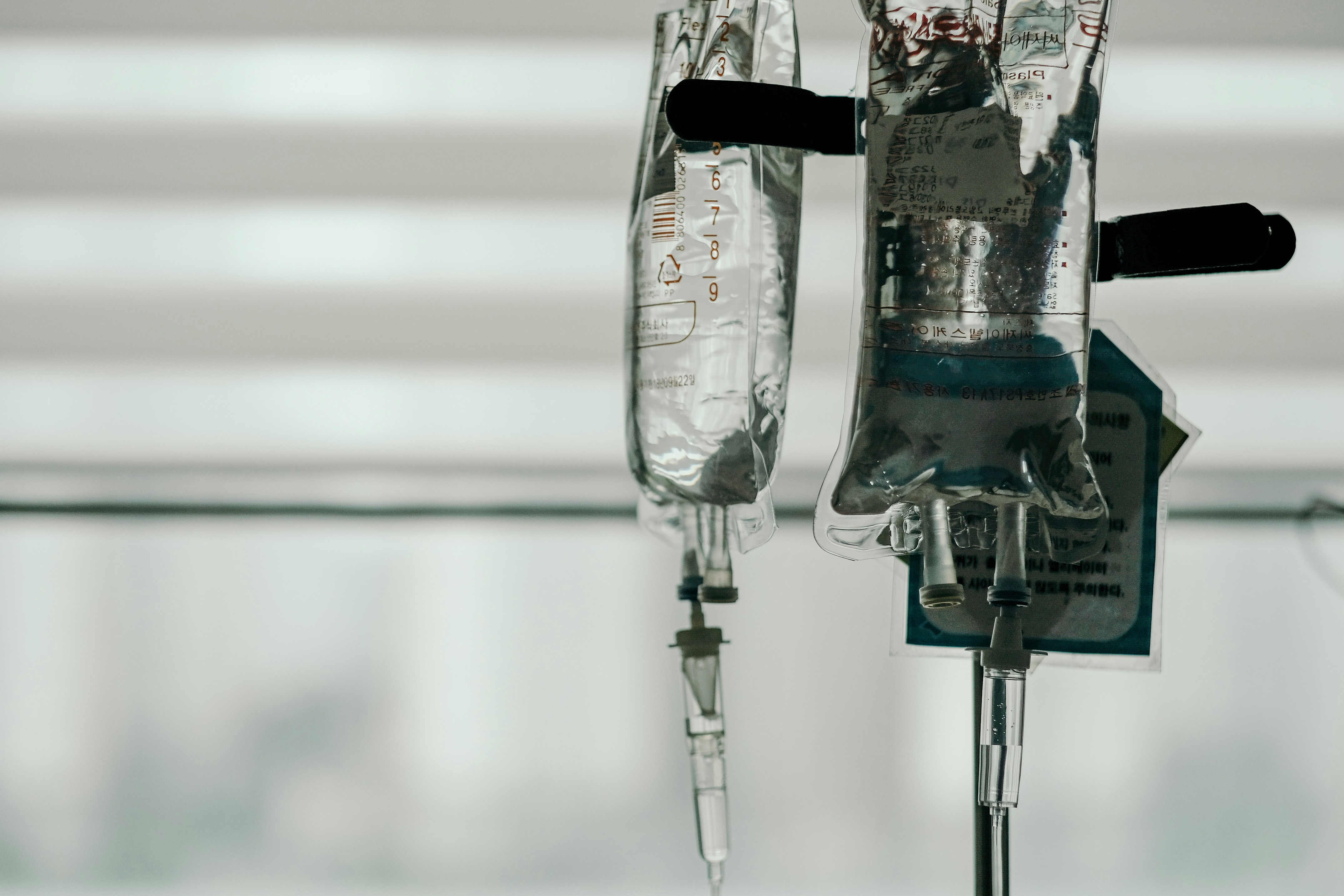 2 IV bags hanging from an IV pole.